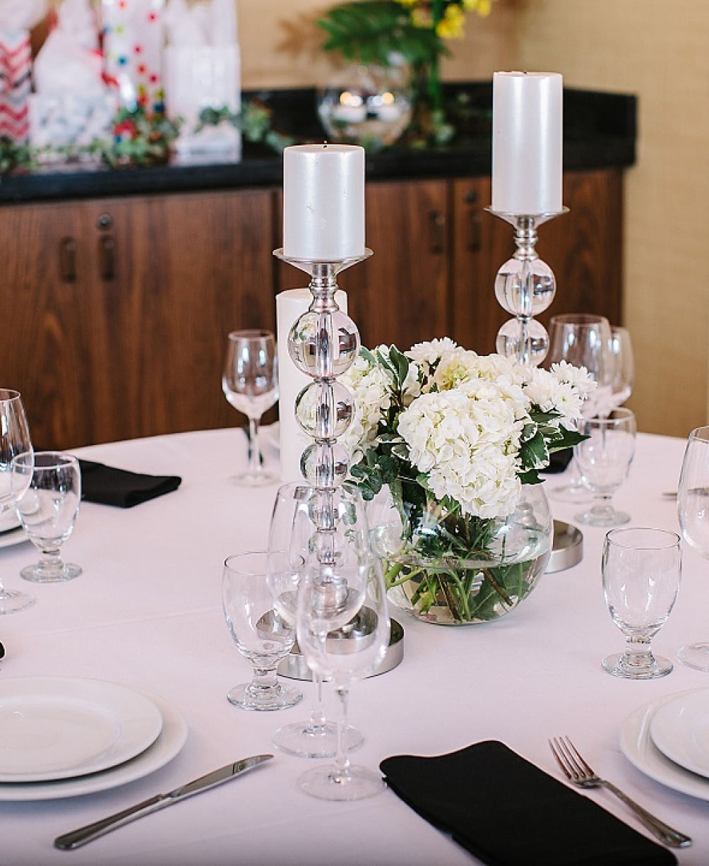 Candles and flowers as a centerpiece on a table setting